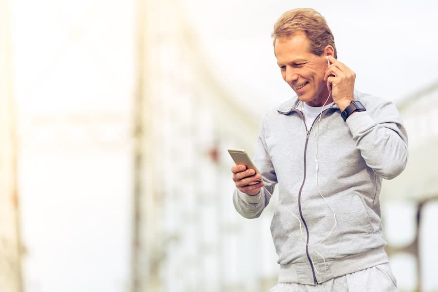 man using iphone with headphones